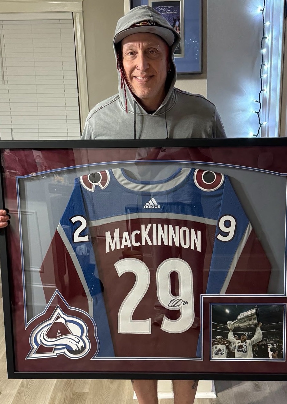 Morgan Rose from Sevendust with his custom framed signed Nathan MacKinnon Avalanche jersey